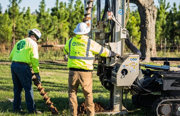 two workers with rig